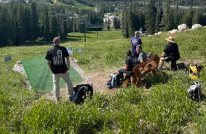 Disc golf players at a tournament waiting at a tee