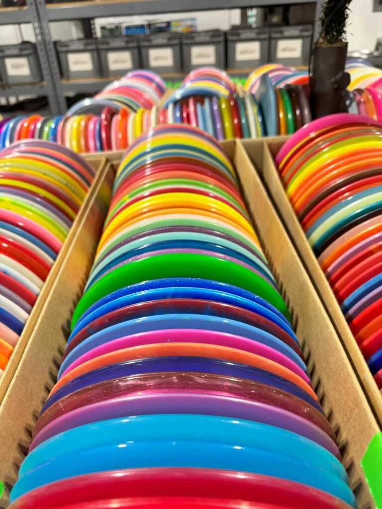 a box full of disc golf discs in a variety of colors