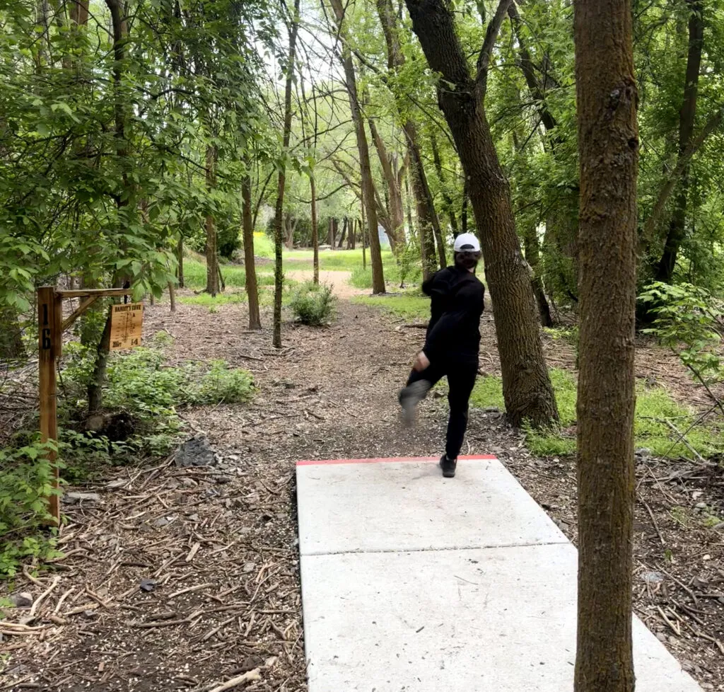 a disc golfer throwing discs.
