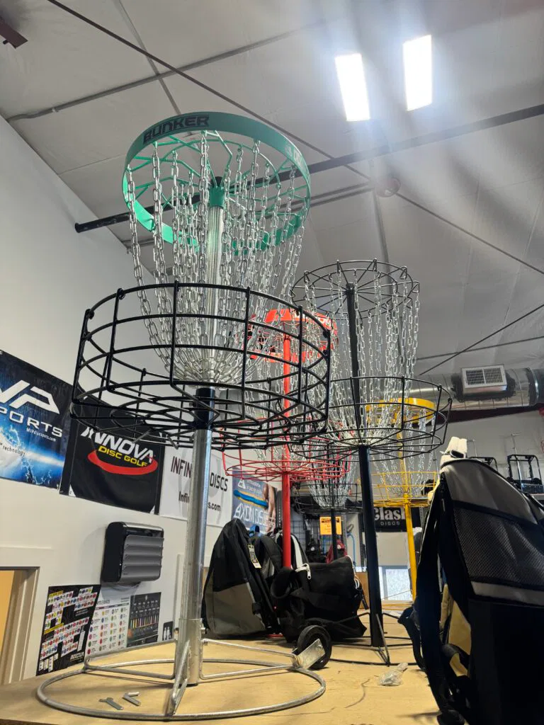 Several disc golf baskets in a DG store