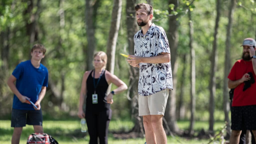A professional disc golfer preparing to throw a tomohawk
