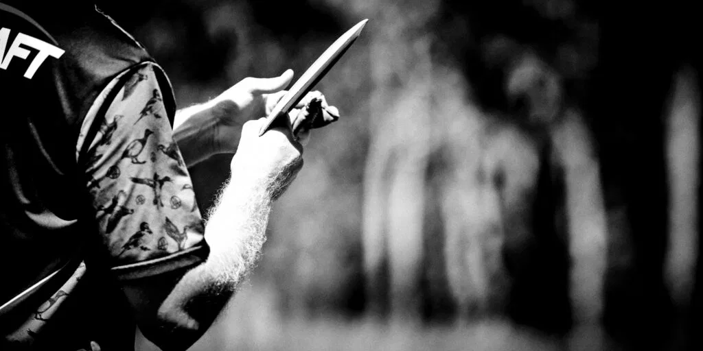 A disc golfer preparing to throw a tomahawk
