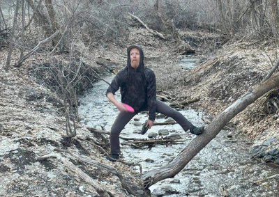 disc golfer putting a disc